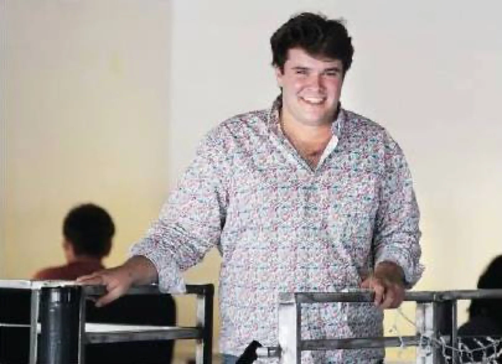 Jon smiling at a table in an earlier chapter of life