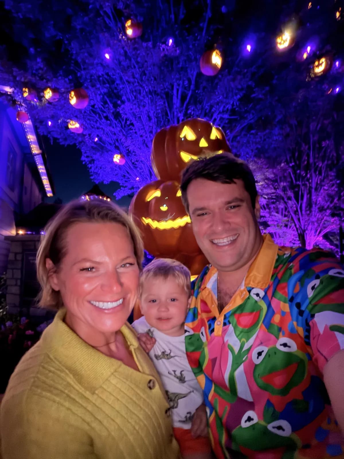 Laura, Jon Bruce, and Jon together in front of illuminated Halloween pumpkins